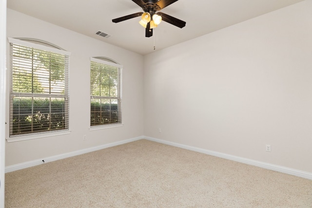 carpeted spare room with ceiling fan