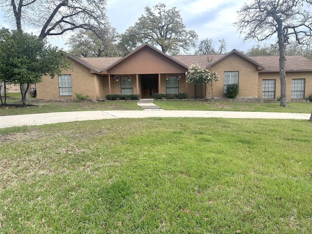 ranch-style home featuring a front yard