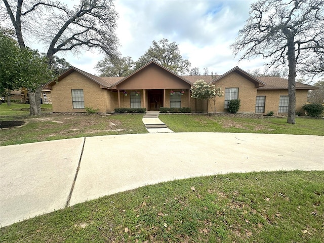 ranch-style home with a front lawn