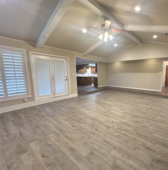 unfurnished living room with light hardwood / wood-style flooring, ceiling fan, and vaulted ceiling with beams