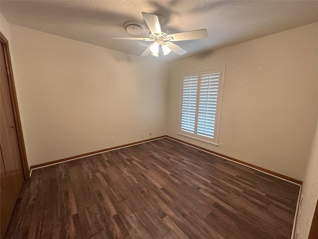 unfurnished room with a textured ceiling, ceiling fan, and dark wood-type flooring