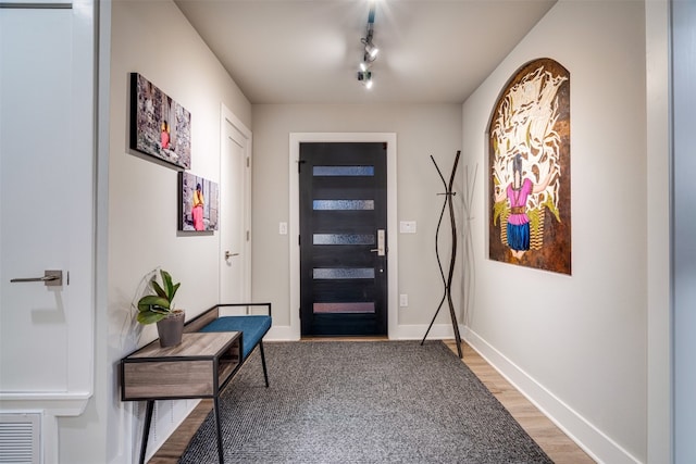 entrance foyer with track lighting and light wood-type flooring