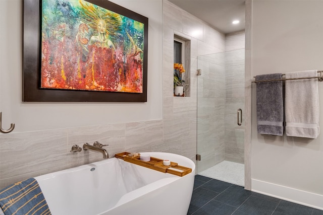 bathroom with shower with separate bathtub, tile walls, and tile floors