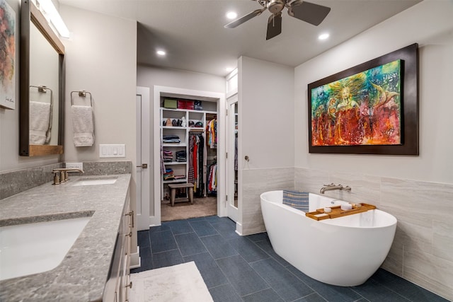 bathroom featuring double sink vanity, french doors, tile flooring, ceiling fan, and tile walls