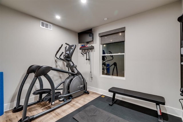 workout room featuring light hardwood / wood-style flooring