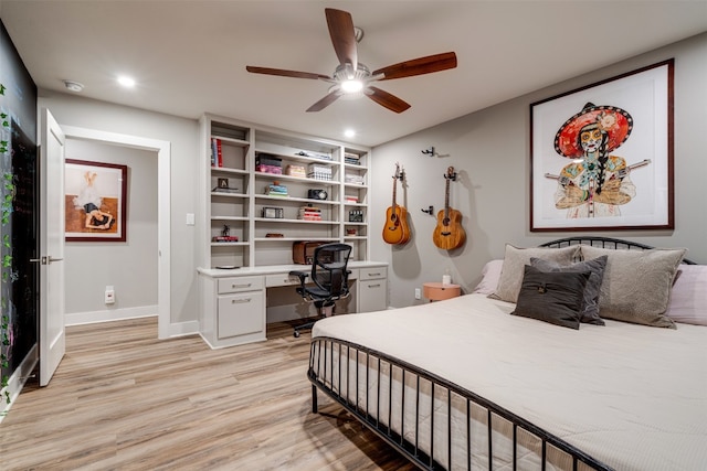 bedroom featuring ceiling fan, built in desk, and light hardwood / wood-style floors