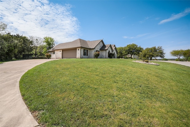 view of front of property with a front lawn and a garage