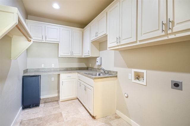 washroom featuring electric dryer hookup, washer hookup, and sink