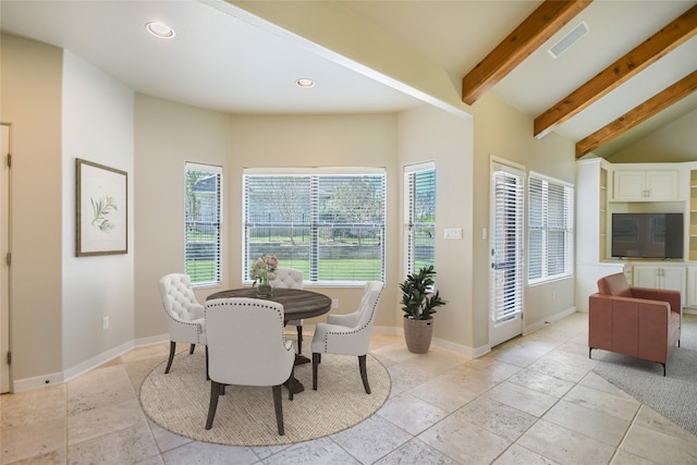 dining area with vaulted ceiling with beams