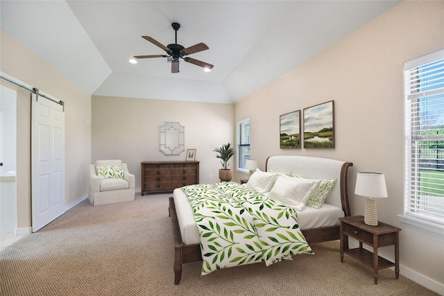 bedroom with light carpet, lofted ceiling, a barn door, and ceiling fan