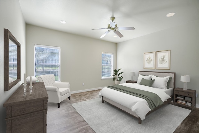 bedroom with ceiling fan and light hardwood / wood-style floors