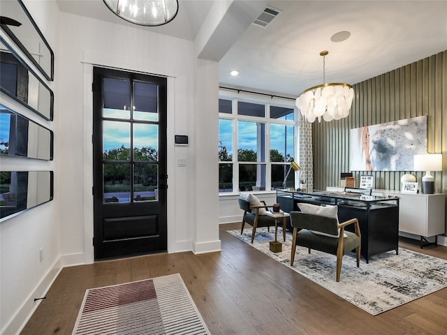 entryway with dark hardwood / wood-style flooring and an inviting chandelier