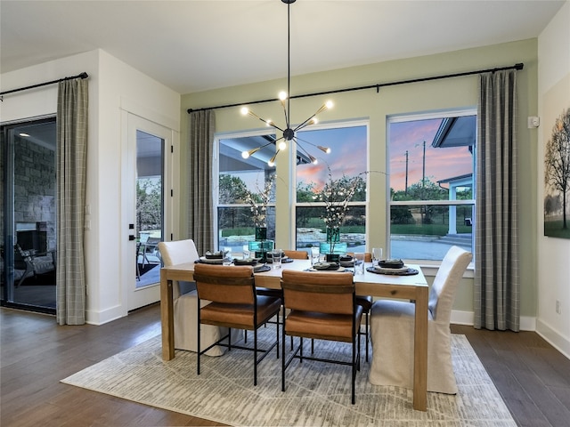 dining area with a chandelier and dark hardwood / wood-style floors