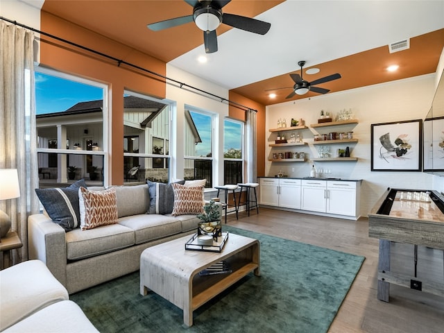 living room with dark hardwood / wood-style flooring and ceiling fan