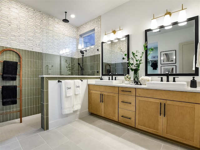 bathroom featuring vanity with extensive cabinet space, double sink, tile flooring, and walk in shower