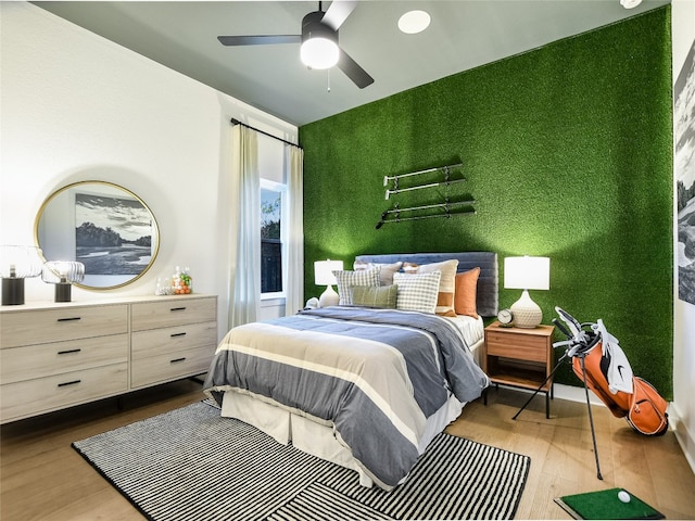 bedroom featuring light hardwood / wood-style flooring and ceiling fan