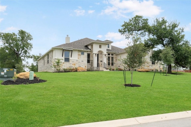 view of front of house featuring stone siding, a chimney, and a front lawn