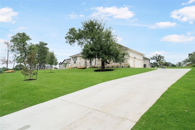 view of front of home featuring a garage and a front lawn