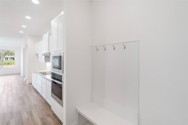 mudroom with light hardwood / wood-style floors