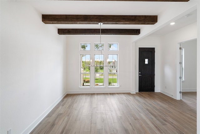 interior space featuring light hardwood / wood-style floors and beam ceiling