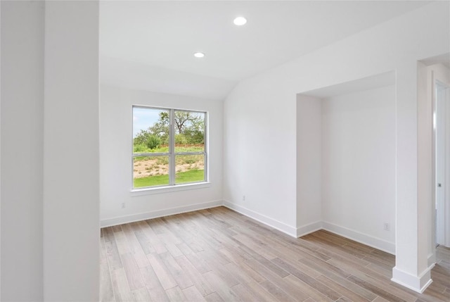 empty room with light wood-type flooring, lofted ceiling, baseboards, and recessed lighting