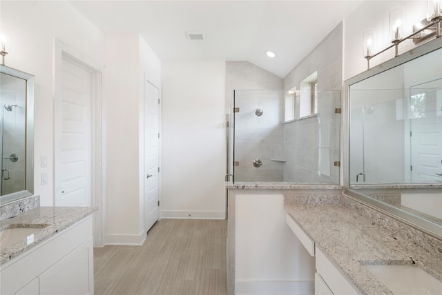 bathroom with vanity, an enclosed shower, tile patterned flooring, and lofted ceiling