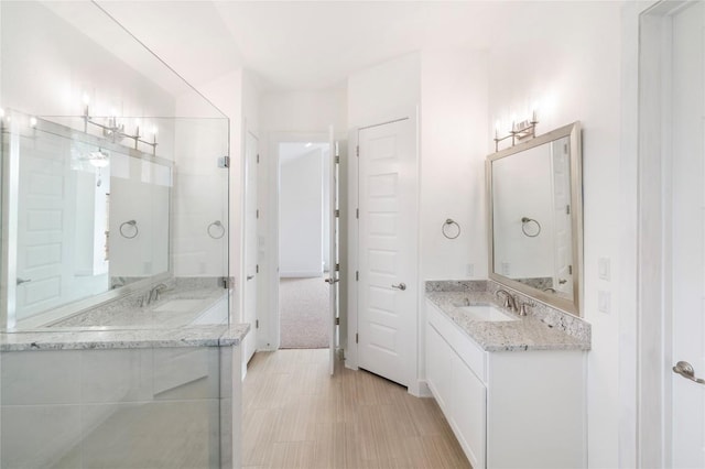 bathroom featuring two vanities and a sink