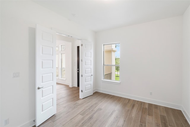 unfurnished room featuring light hardwood / wood-style floors