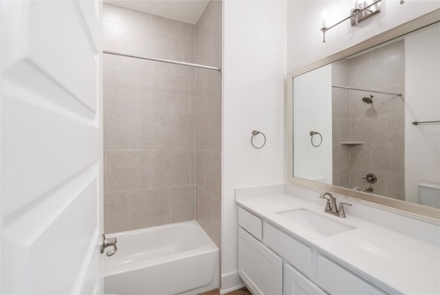 full bathroom featuring toilet, tiled shower / bath combo, and vanity