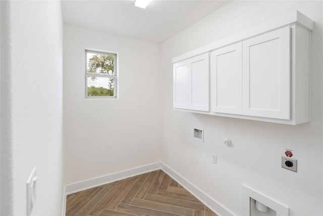 laundry area with cabinet space, baseboards, gas dryer hookup, hookup for a washing machine, and electric dryer hookup