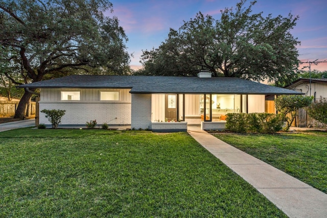 ranch-style home featuring a yard