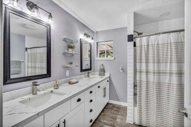 bathroom featuring double sink, large vanity, and hardwood / wood-style floors