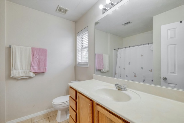 bathroom featuring tile flooring, oversized vanity, and toilet