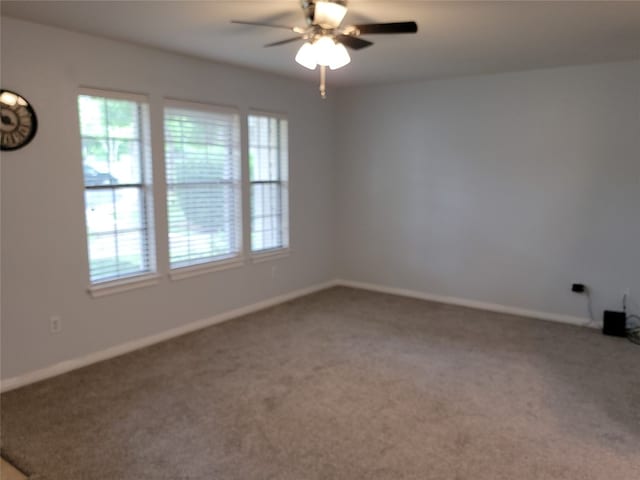 carpeted spare room featuring ceiling fan