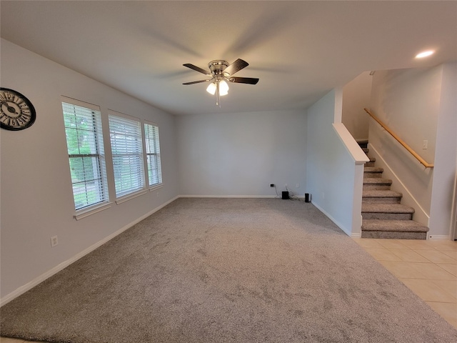 unfurnished living room with ceiling fan and light colored carpet