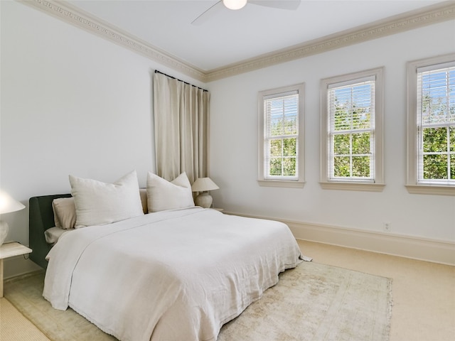 bedroom with ceiling fan, multiple windows, ornamental molding, and light carpet