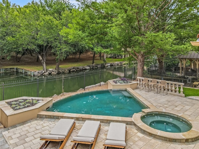 view of pool with an outdoor fire pit, a patio, and an in ground hot tub