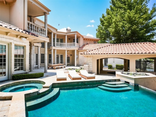 view of swimming pool with an in ground hot tub and a patio