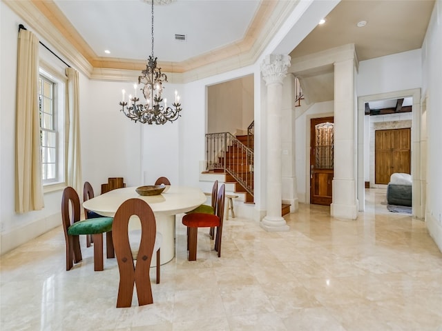 dining area featuring light tile floors, a notable chandelier, crown molding, and decorative columns