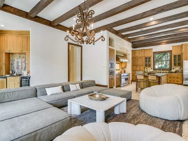 living room with a notable chandelier, wine cooler, and beamed ceiling