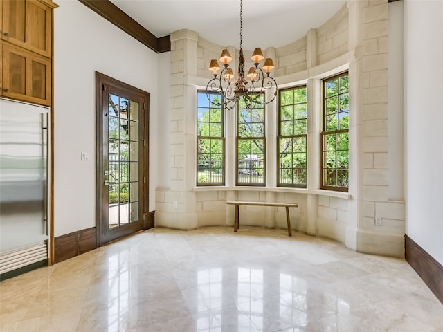 empty room with light tile flooring, ornamental molding, a chandelier, and a healthy amount of sunlight