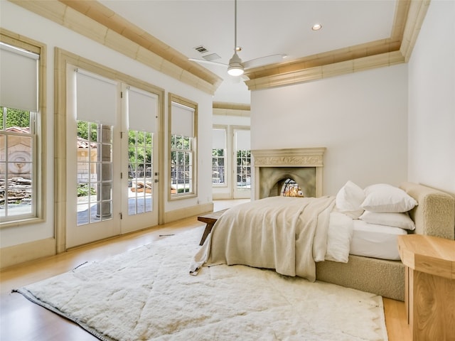 bedroom with access to exterior, ceiling fan, and light wood-type flooring