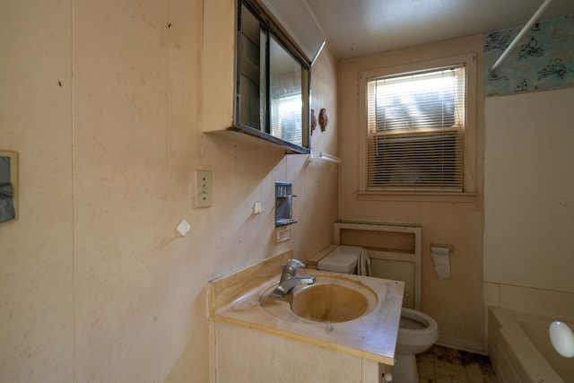 full bathroom featuring tile floors, toilet, vanity with extensive cabinet space, and bathtub / shower combination