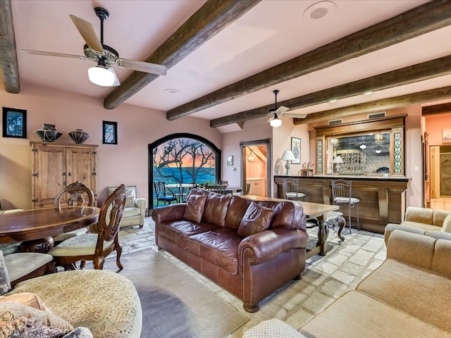 living room featuring ceiling fan and beam ceiling