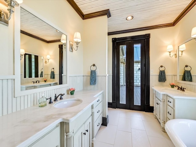 bathroom with double vanity, tile flooring, a bathtub, and crown molding