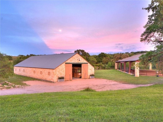 view of front of property with a yard and an outdoor structure