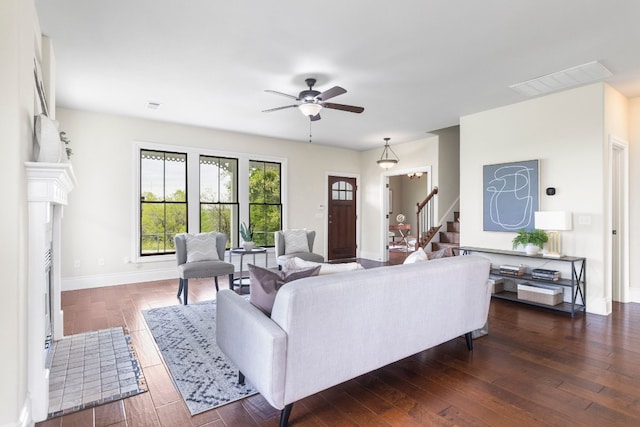 living room with ceiling fan and dark hardwood / wood-style flooring