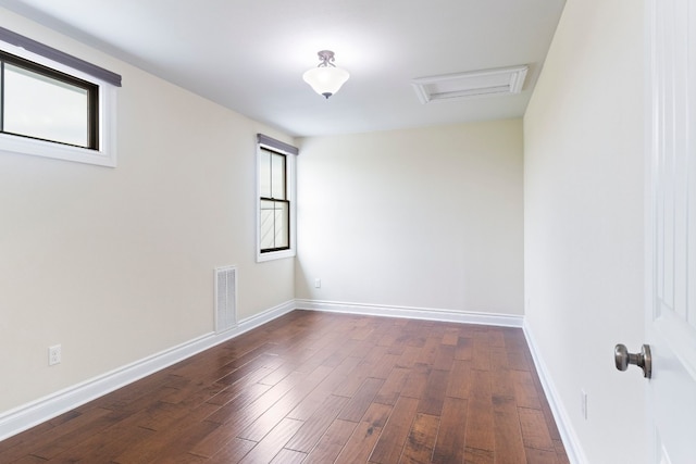 empty room with dark hardwood / wood-style flooring