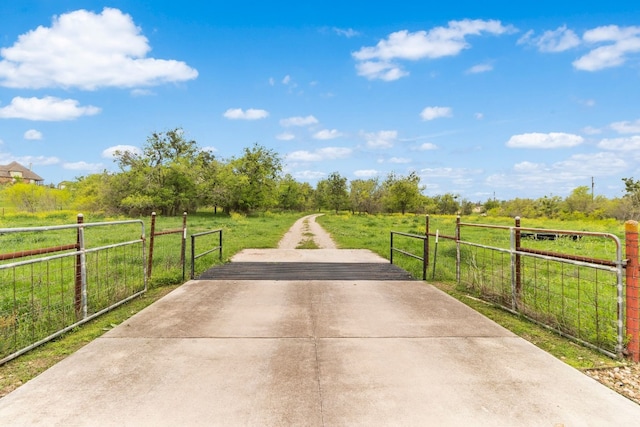 surrounding community with a rural view and a lawn