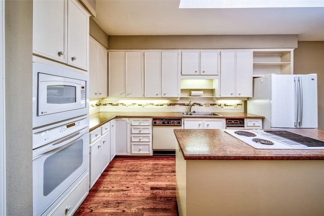 kitchen with dark hardwood / wood-style floors, white cabinetry, sink, decorative backsplash, and white appliances